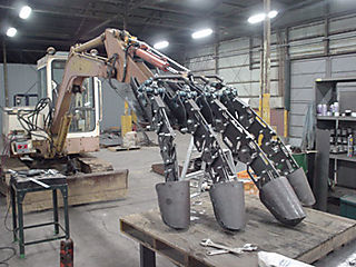 Kogoro Kurata working on a giant, bone crushing Mech