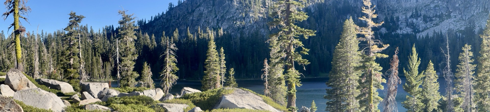 Panorama of Frog Lake through granite boulders and pines