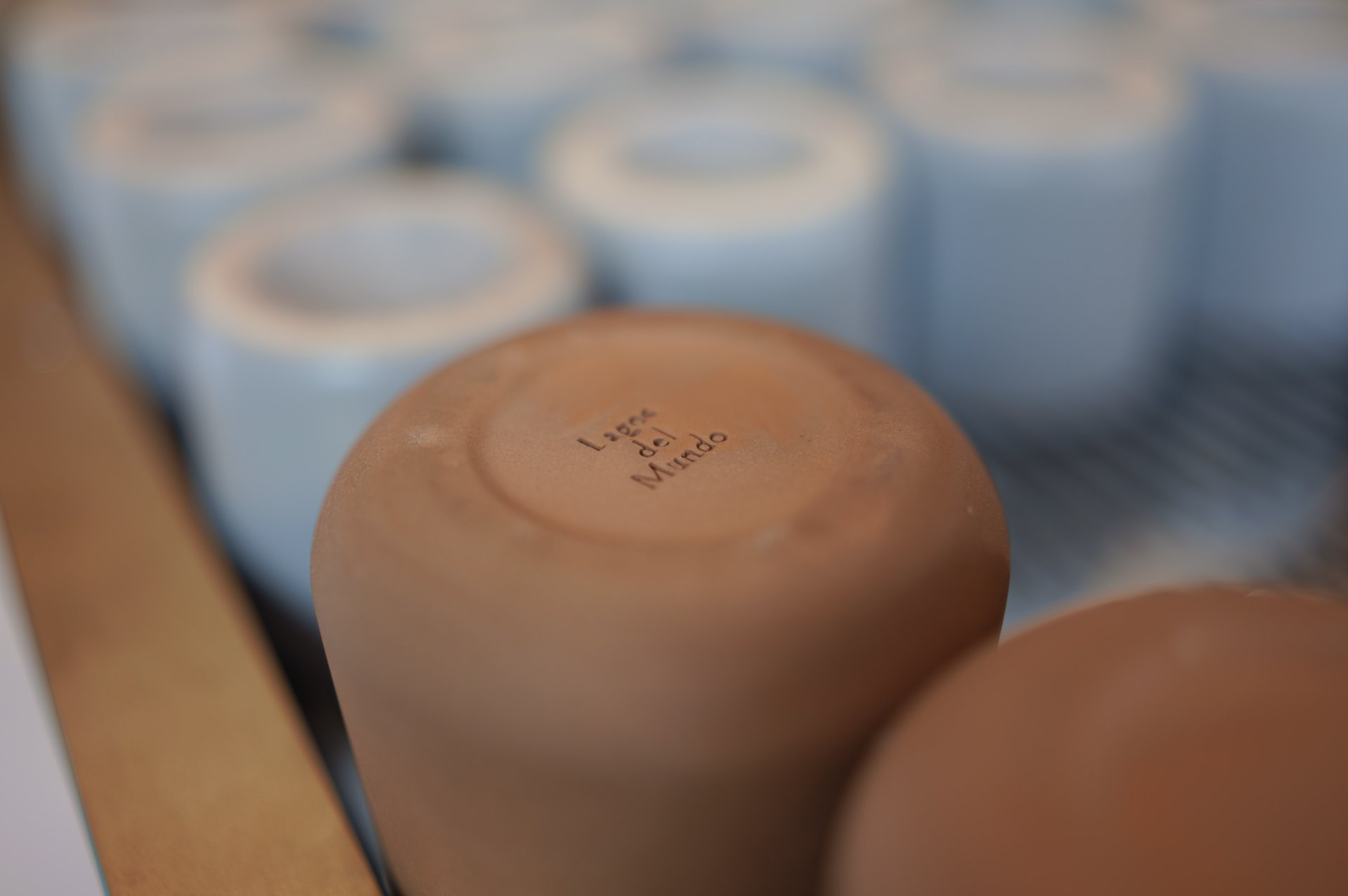 Terracotta cups upside down on the espresso machine at Chula Café